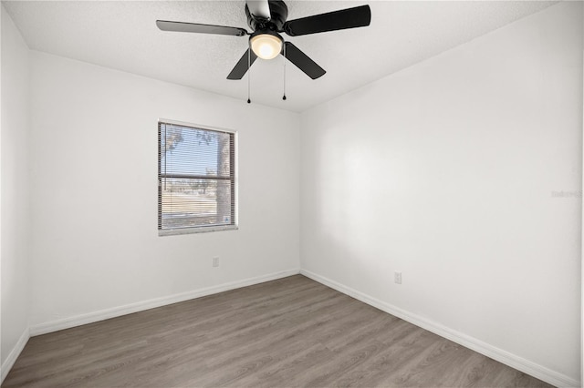 spare room featuring ceiling fan, hardwood / wood-style floors, and a textured ceiling