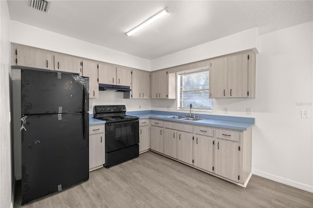 kitchen featuring sink, light brown cabinets, black appliances, and light wood-type flooring