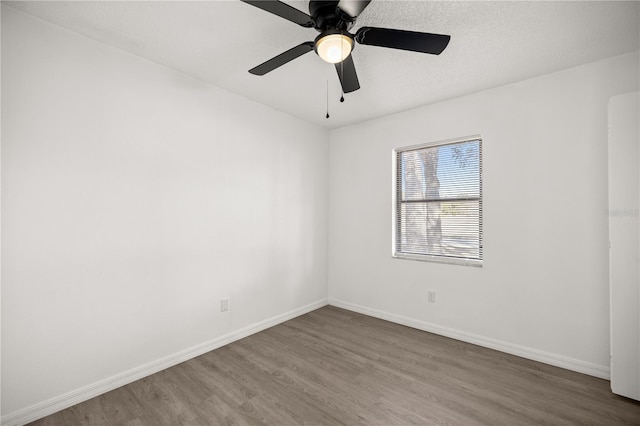 empty room with hardwood / wood-style flooring, ceiling fan, and a textured ceiling