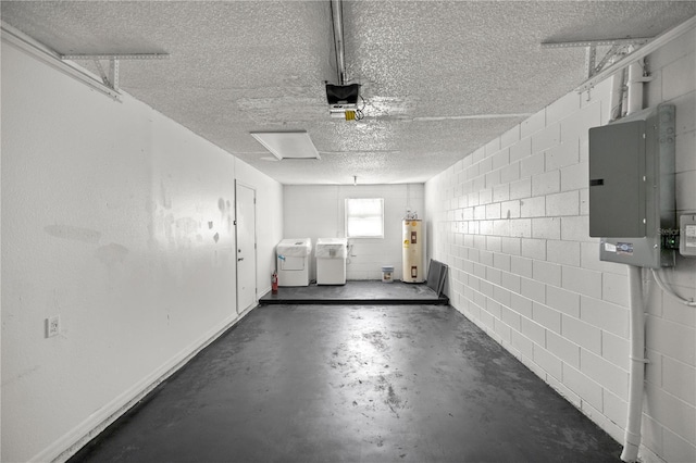 garage featuring separate washer and dryer, a garage door opener, electric panel, and water heater