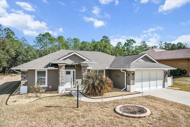 ranch-style house featuring a garage and a front lawn