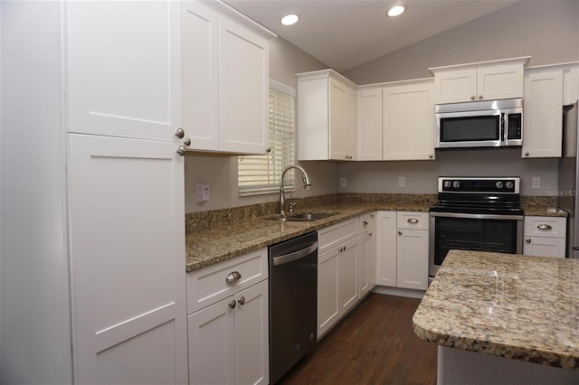 kitchen featuring light stone counters, sink, stainless steel appliances, and white cabinets