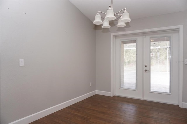 doorway featuring dark hardwood / wood-style floors, a chandelier, and french doors