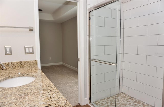 bathroom with vanity and a shower with shower door