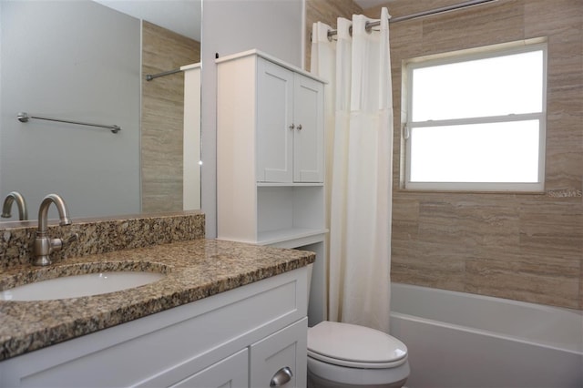 full bathroom with vanity, shower / tub combo, and toilet