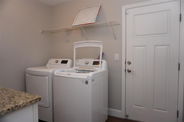 clothes washing area with washing machine and clothes dryer