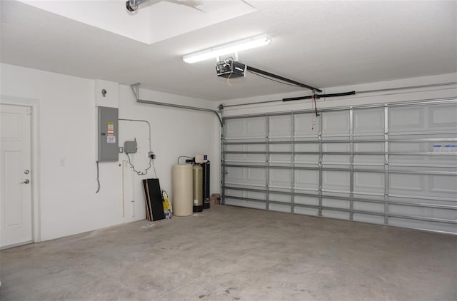 garage with a garage door opener and electric panel