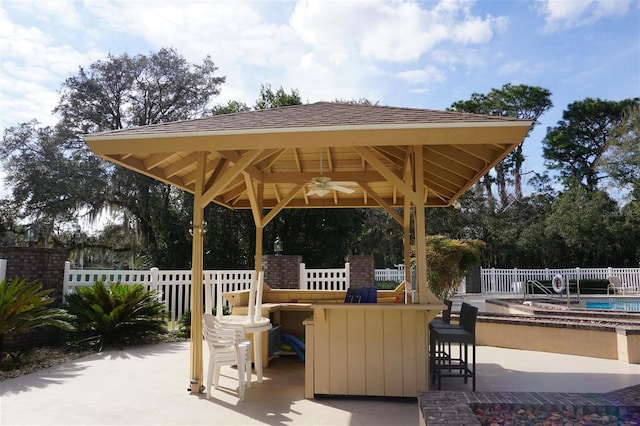 view of patio / terrace with a gazebo, an outdoor bar, and ceiling fan