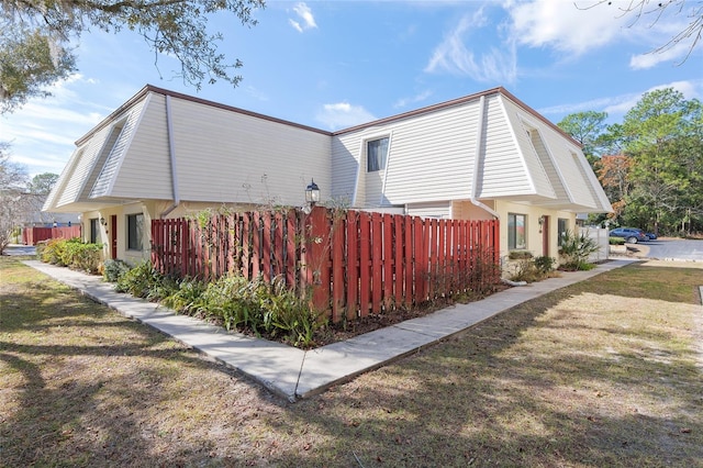 view of property exterior featuring a lawn