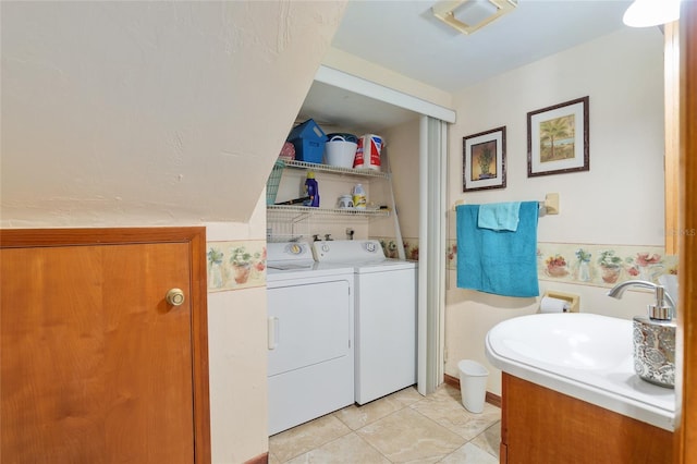 washroom with independent washer and dryer, sink, and light tile patterned floors