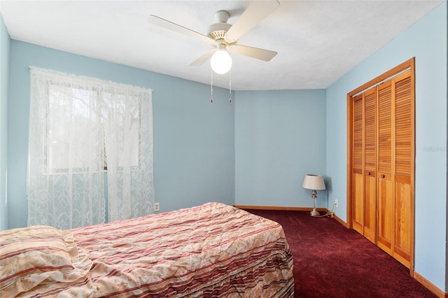 carpeted bedroom featuring a closet and ceiling fan