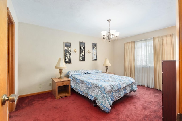 bedroom featuring a chandelier and dark carpet