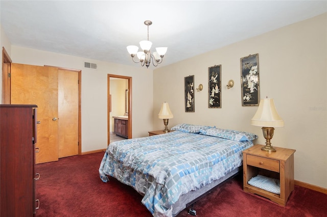 carpeted bedroom featuring an inviting chandelier