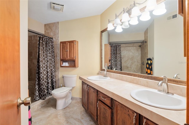 bathroom with vanity, tile patterned flooring, toilet, and walk in shower