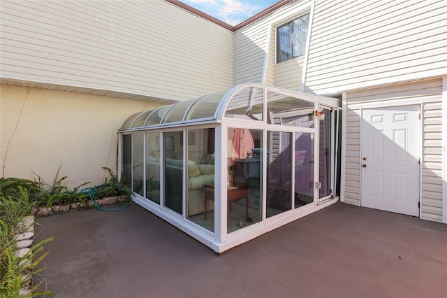 view of patio with a sunroom