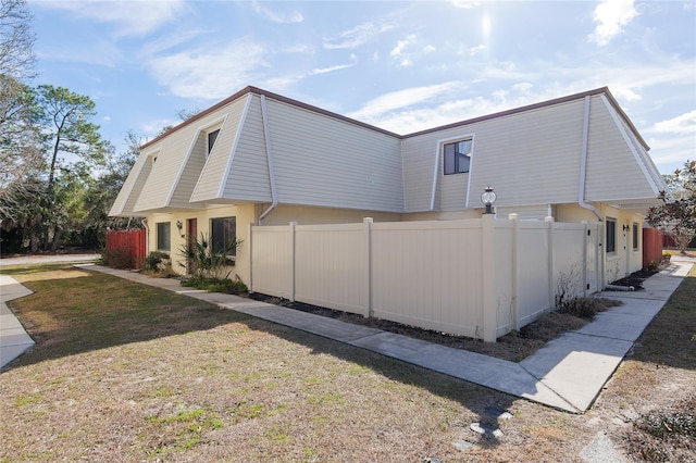 view of side of home featuring a lawn