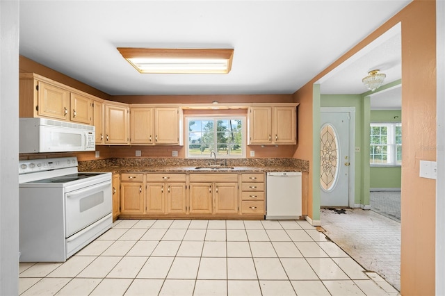 kitchen with a healthy amount of sunlight, sink, light brown cabinetry, and white appliances