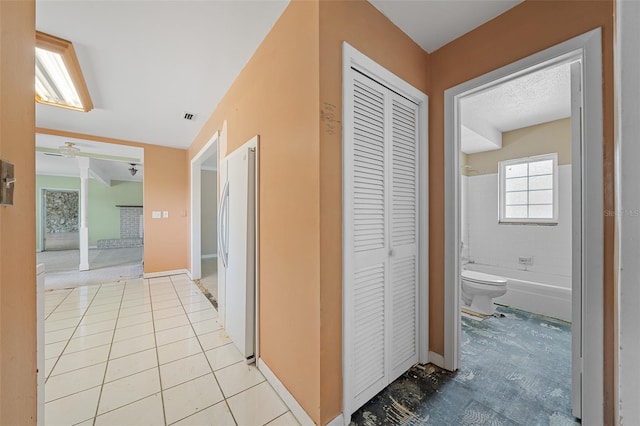 corridor featuring light tile patterned floors