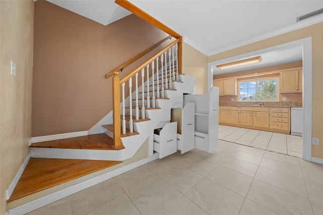 staircase featuring crown molding and tile patterned floors