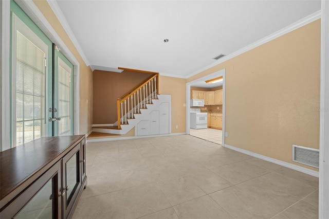 tiled foyer entrance featuring crown molding and french doors