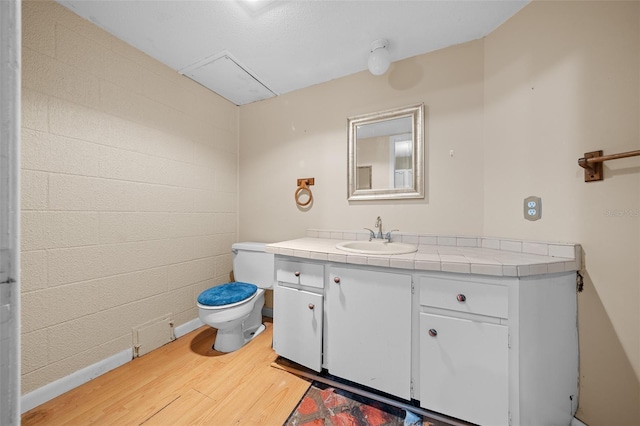 bathroom featuring vanity, hardwood / wood-style floors, and toilet