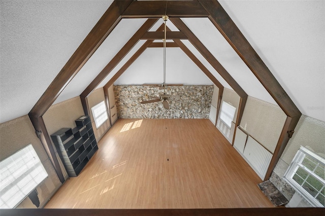 bonus room featuring lofted ceiling with beams and light hardwood / wood-style flooring