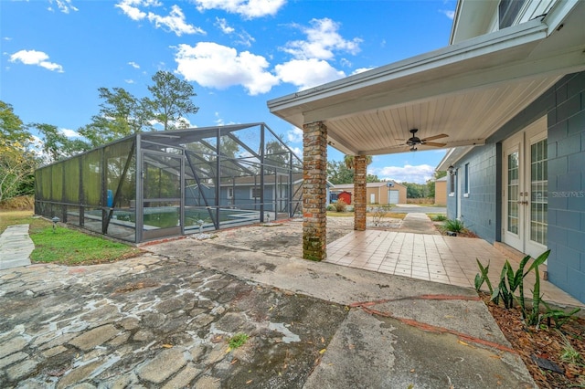 view of patio featuring glass enclosure