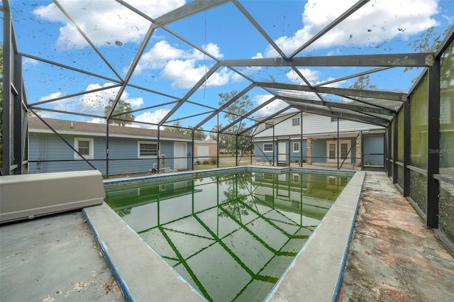 view of swimming pool with a lanai and a patio