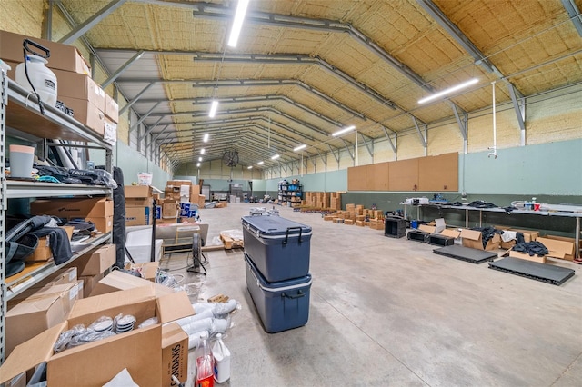 misc room with high vaulted ceiling and concrete floors