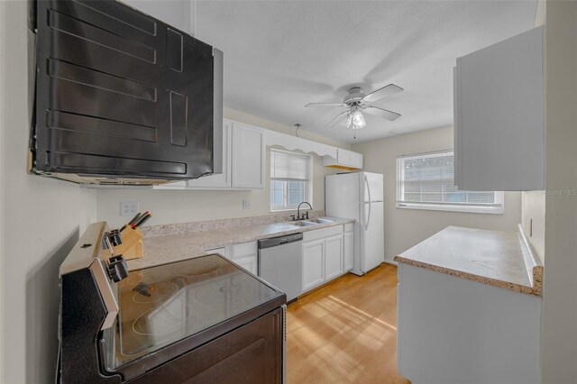 kitchen with sink, white cabinets, white fridge, stainless steel dishwasher, and electric stove