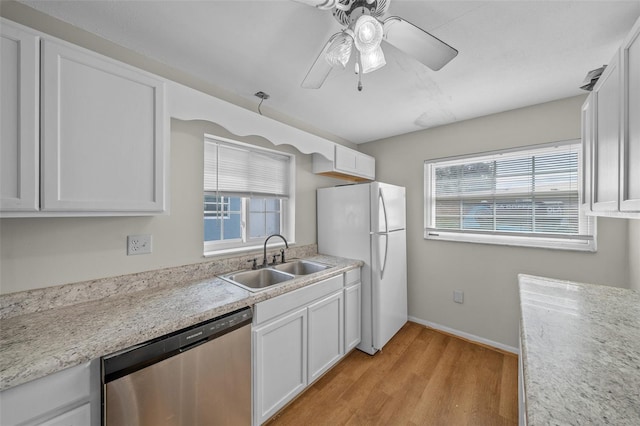 kitchen featuring dishwasher, sink, white fridge, and white cabinets