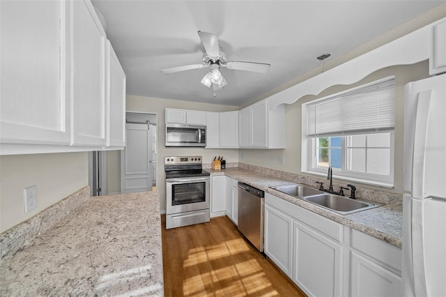 kitchen with appliances with stainless steel finishes, sink, and white cabinets