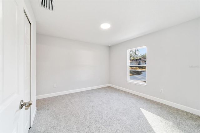 unfurnished room with light carpet