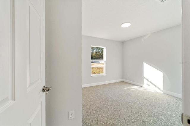 empty room featuring light carpet