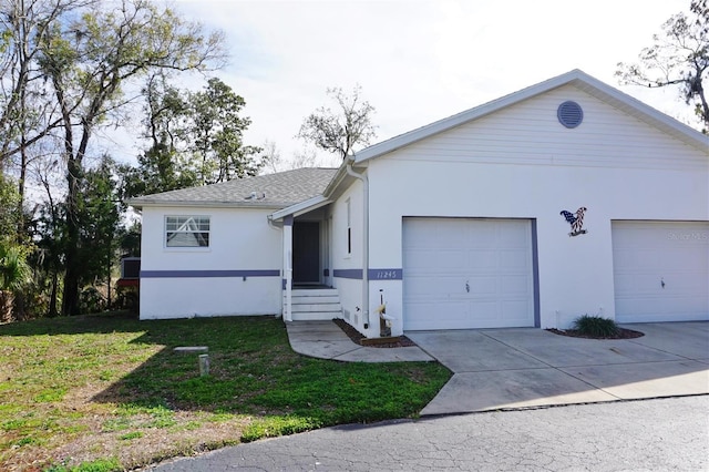 ranch-style house featuring a garage and a front yard