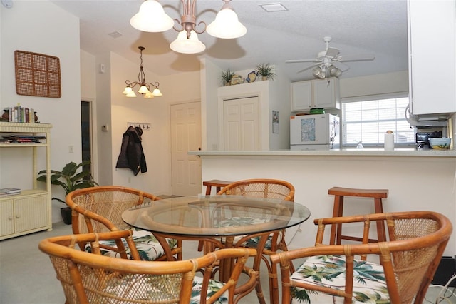 dining area featuring lofted ceiling, ceiling fan with notable chandelier, and carpet floors