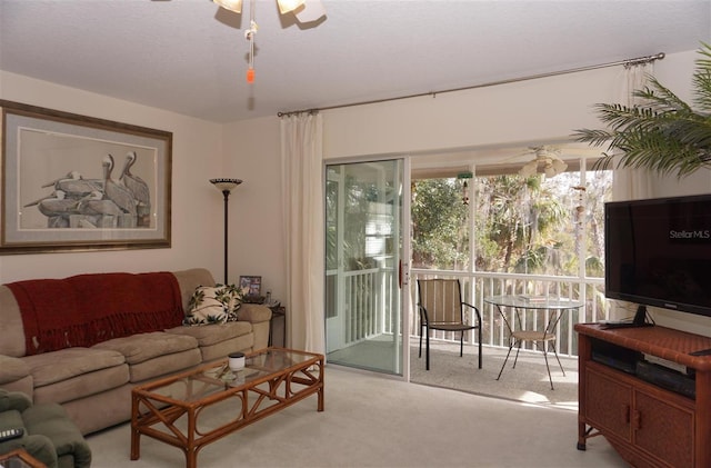 living room with light carpet and ceiling fan