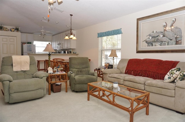 carpeted living room featuring ceiling fan