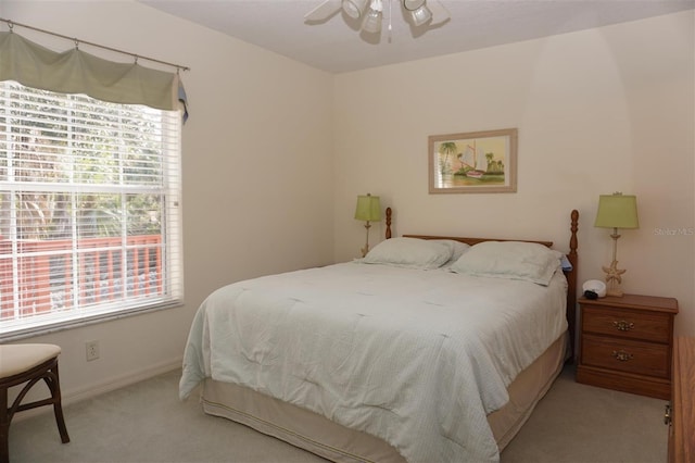 bedroom with ceiling fan and light colored carpet