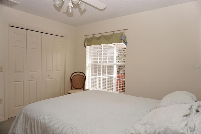 bedroom with ceiling fan and a closet