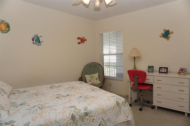 bedroom with light carpet and ceiling fan