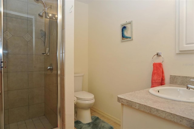 bathroom with tile patterned floors, vanity, toilet, and a shower with shower door