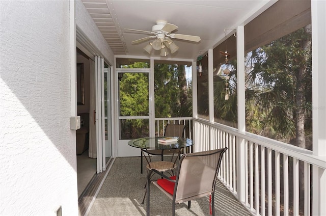 sunroom / solarium featuring ceiling fan