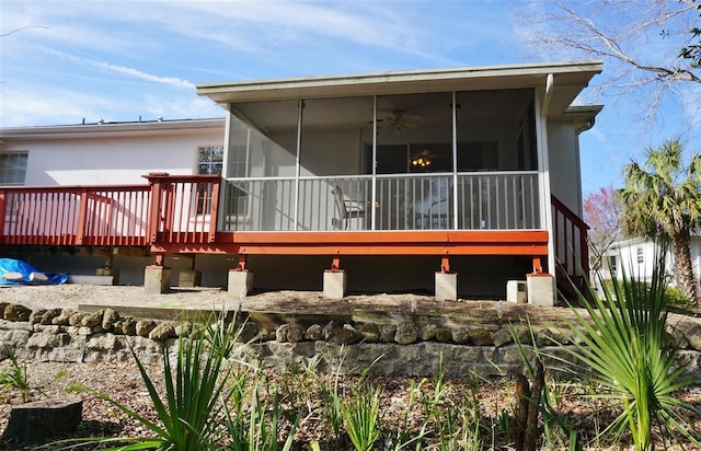 rear view of property featuring a sunroom