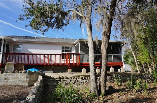 rear view of house featuring a deck