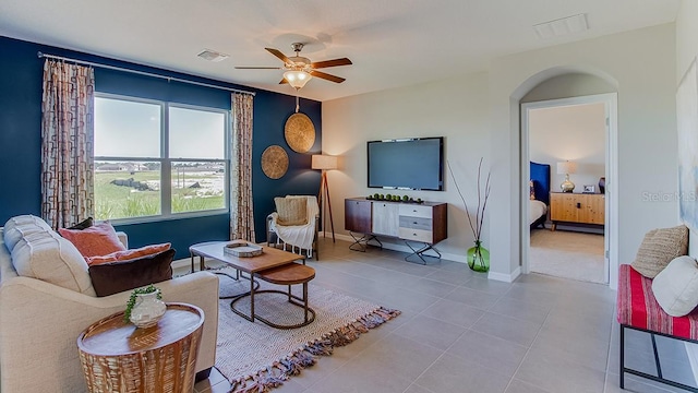 tiled living room featuring ceiling fan