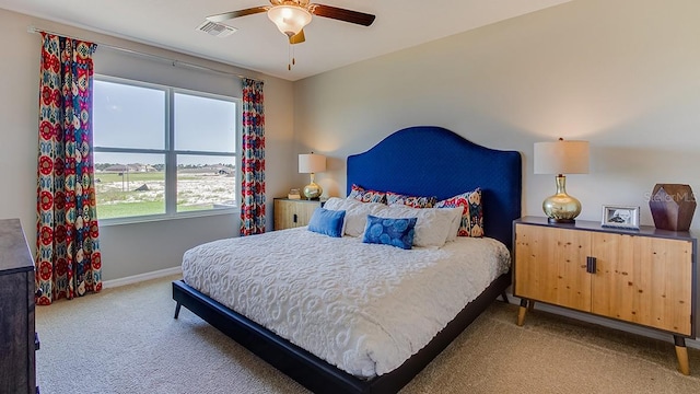 bedroom featuring light colored carpet and ceiling fan