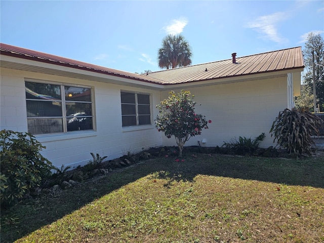 view of property exterior featuring a lawn