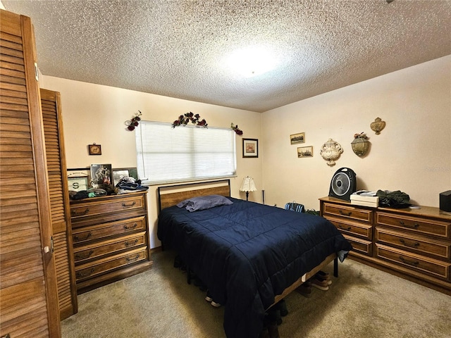 bedroom featuring light carpet and a textured ceiling