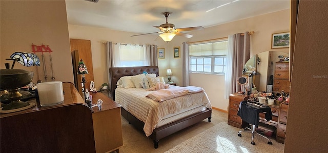 bedroom featuring light carpet and ceiling fan